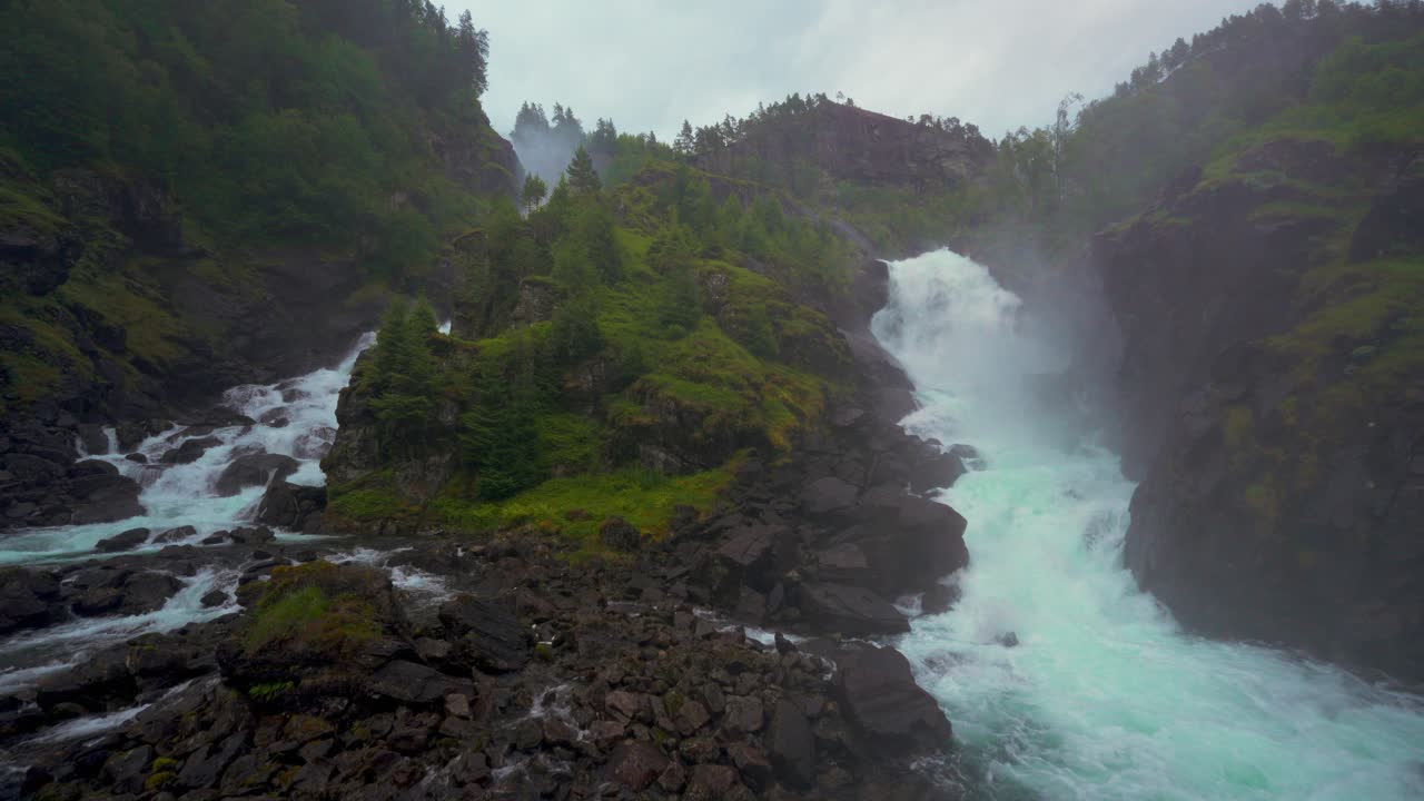 Powerful Waterfall in a Lush Green Mountain Landscape