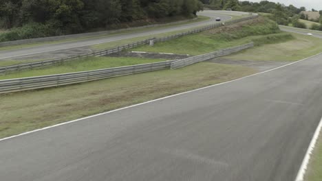 cars driving along circuit of pau-arnos, france