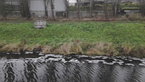 factory water discharge and dirty footprint in the river