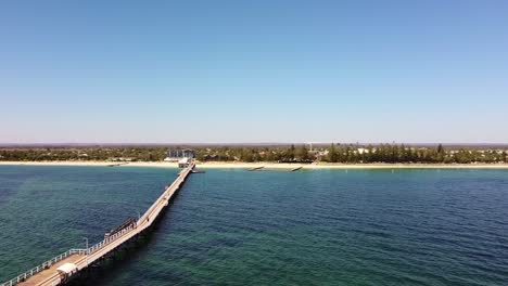 scenic view of a long pier and coastal town