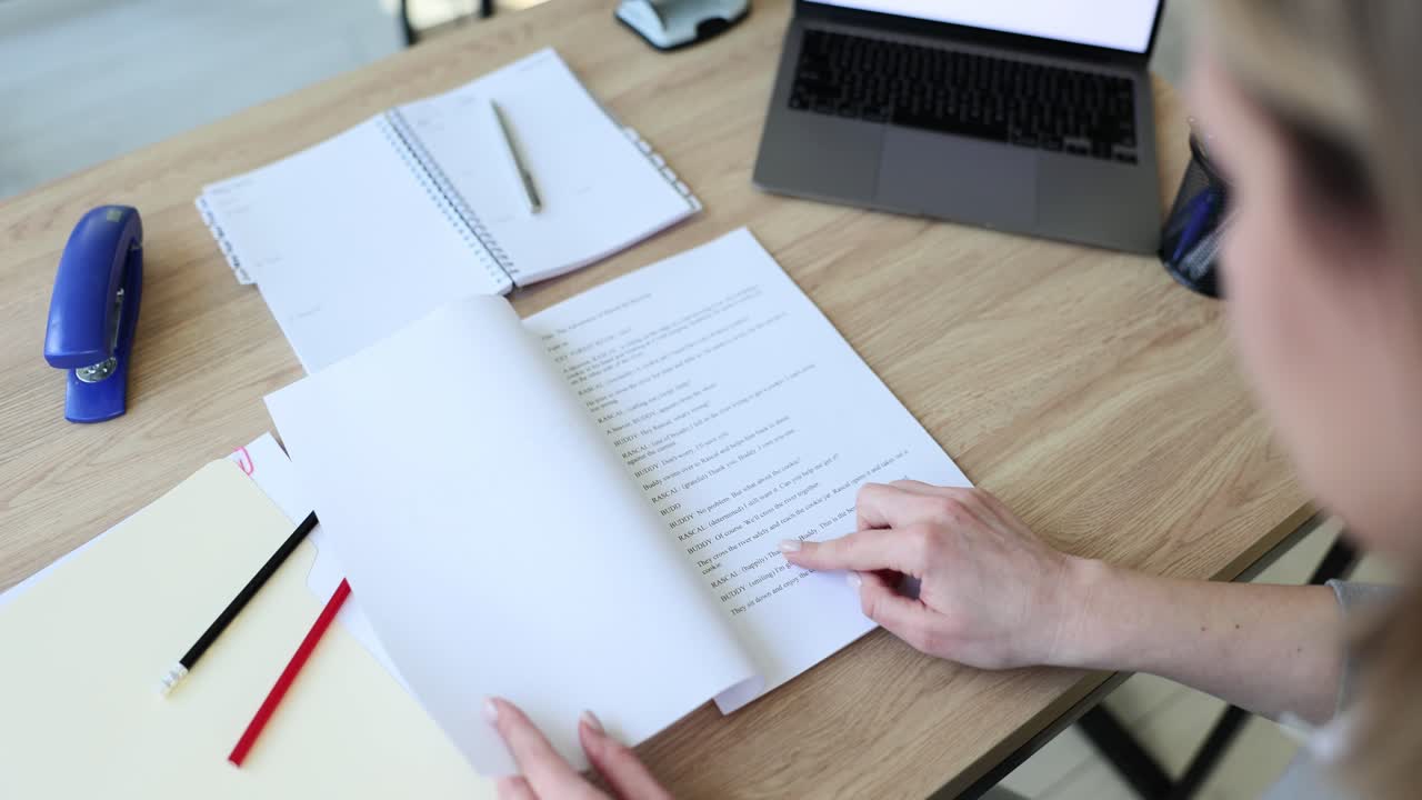 Person Reading a Script or Document at a Desk
