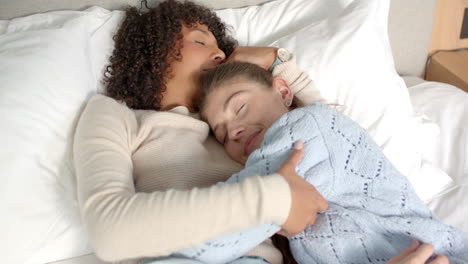 resting together, lesbian couple cuddling on bed, enjoying peaceful moment