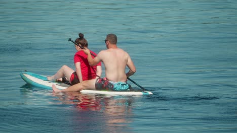 surfboard freedom, aquatic adventures, couple together, slow motion