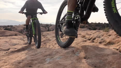 two-athletic-men-mountain-biking-in-the-wilderness