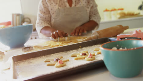 smiling senior woman preparing cookies in kitchen 4k