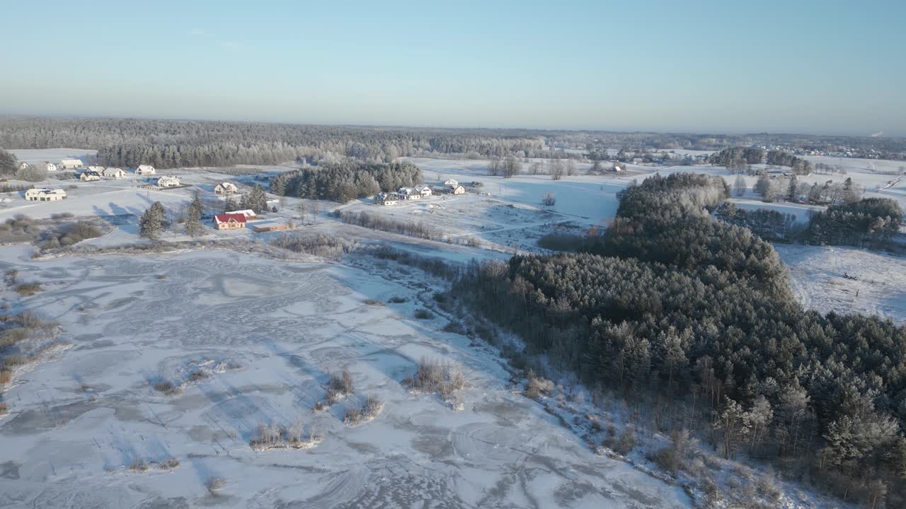 Rural homes in a snowy landscape, bird's-eye view