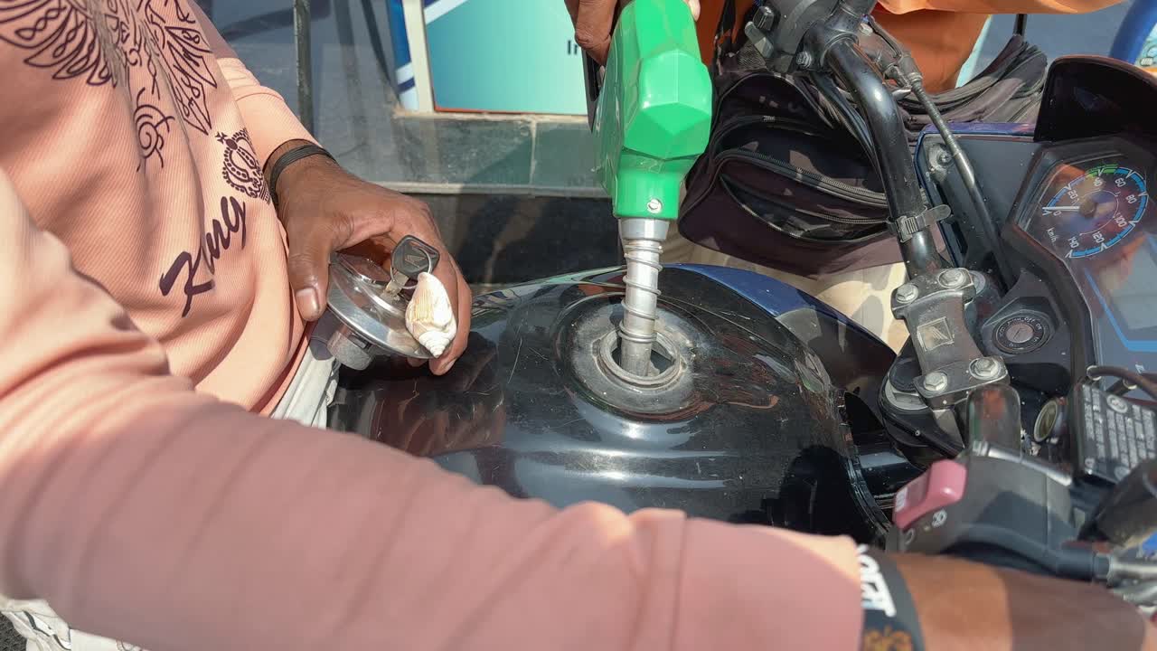 Refueling a Motorcycle at a Gas Station