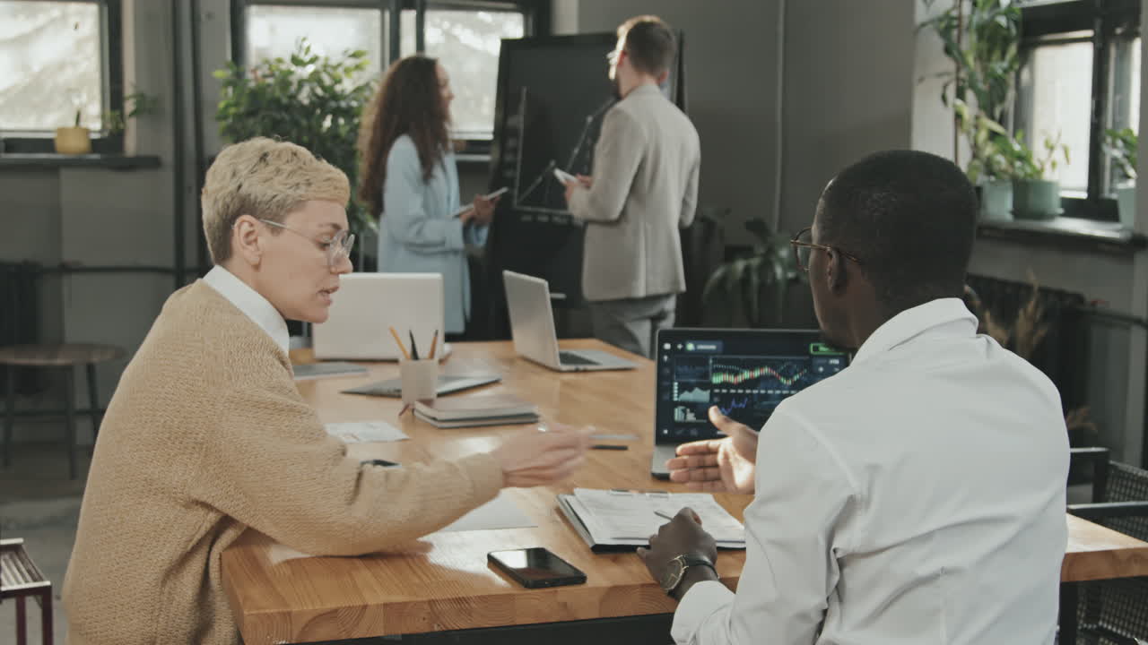 Multi-Ethnic Coworkers Examining Business Documents