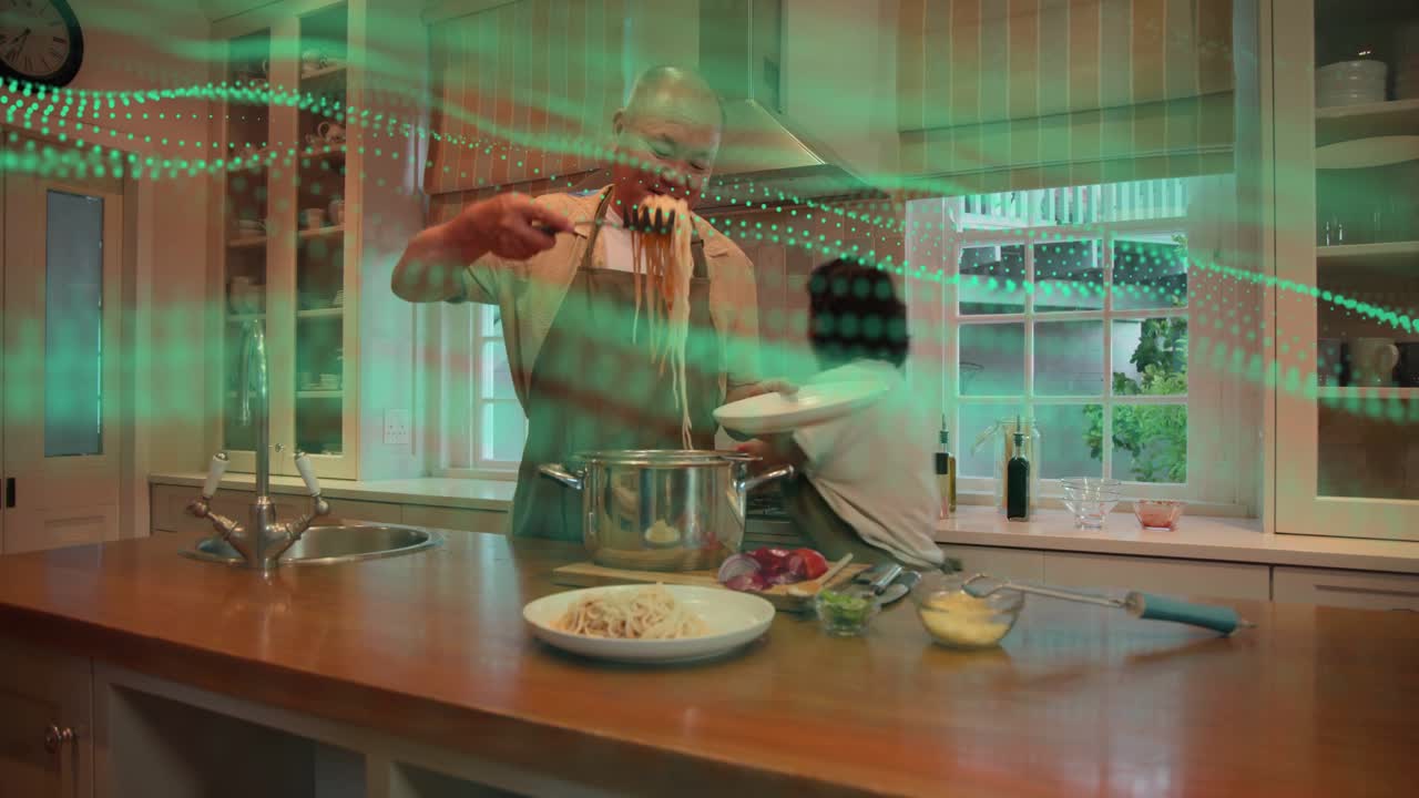 Man lifting pasta from pot, woman holding plates on island, green overlay guiding food plating
