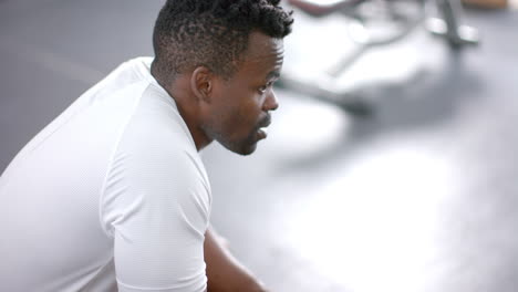 Fit-African-American-man-takes-a-break-at-the-gym,-with-copy-space