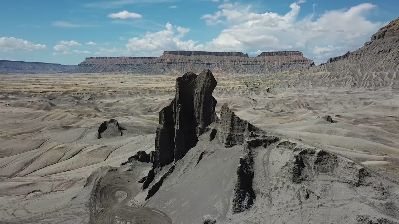 Aerial View of Utah Desert, Black Sandstone Cliff and Factory Butte USA. Dry Landscape Under Evening Sunlight