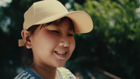 smiling girl in a baseball cap