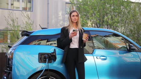 woman plugs in charger into socket of her modern new electric car. woman makes power supply plugged into an electric car being charged