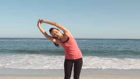 Attractive-woman-stretching-on-the-beach