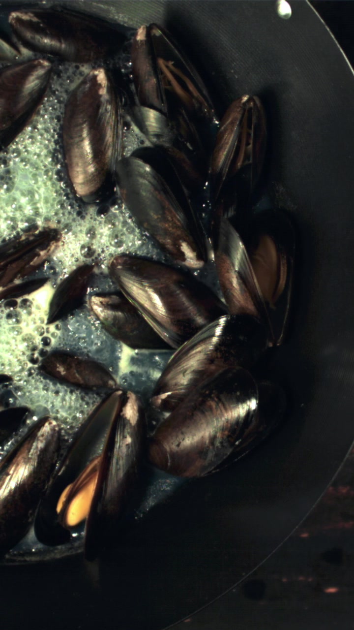 Fresh Mussels Steaming in a Pan with Bubbling Sauce