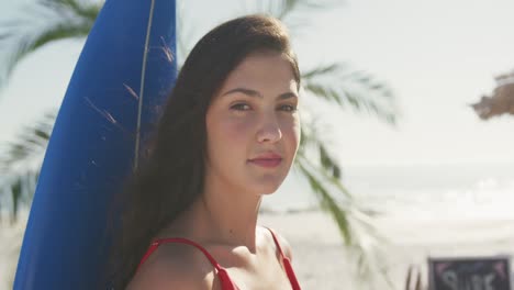 caucasian woman ready to go surf