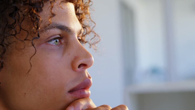 Side view of Caucasian male graphic designer with hand on chin working at desk in office 4k