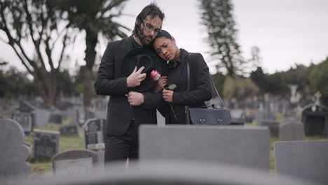 Couple,-sad-and-mourning-at-tomb-of-graveyard