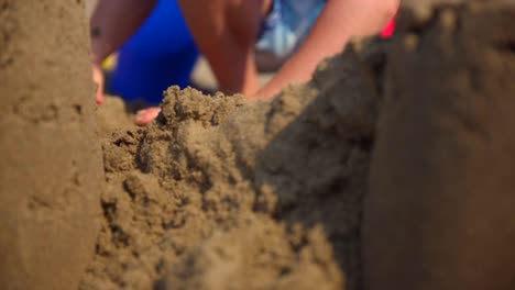 child building sandcastle on the beach