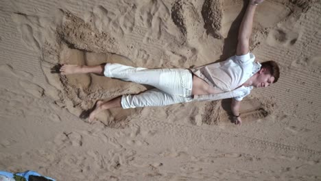 man relax on beach. man lying on sand. beach relax. man relaxing on sand