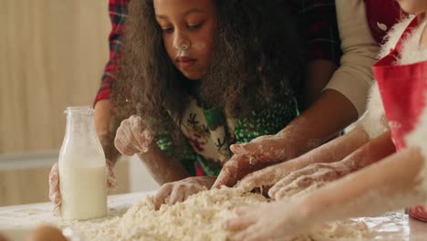 push in view of family kneading dough for christmas cookies