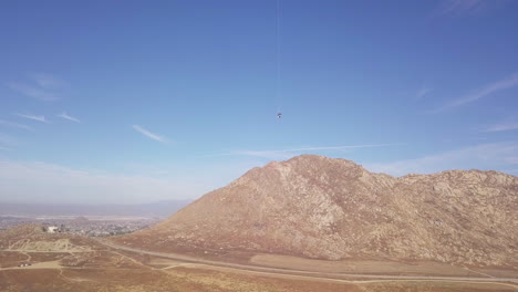 falcon bird of prey flies crazy high altitude in california desert