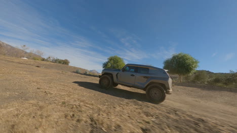 fpv tracking shot of a new police suv over a desert kicking up dust