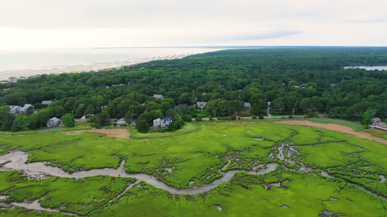 Vast wetlands filled with winding channels and reflective pools form natural patterns in the marsh, revealed in high drone perspective that emphasizes both texture and expansive scenery