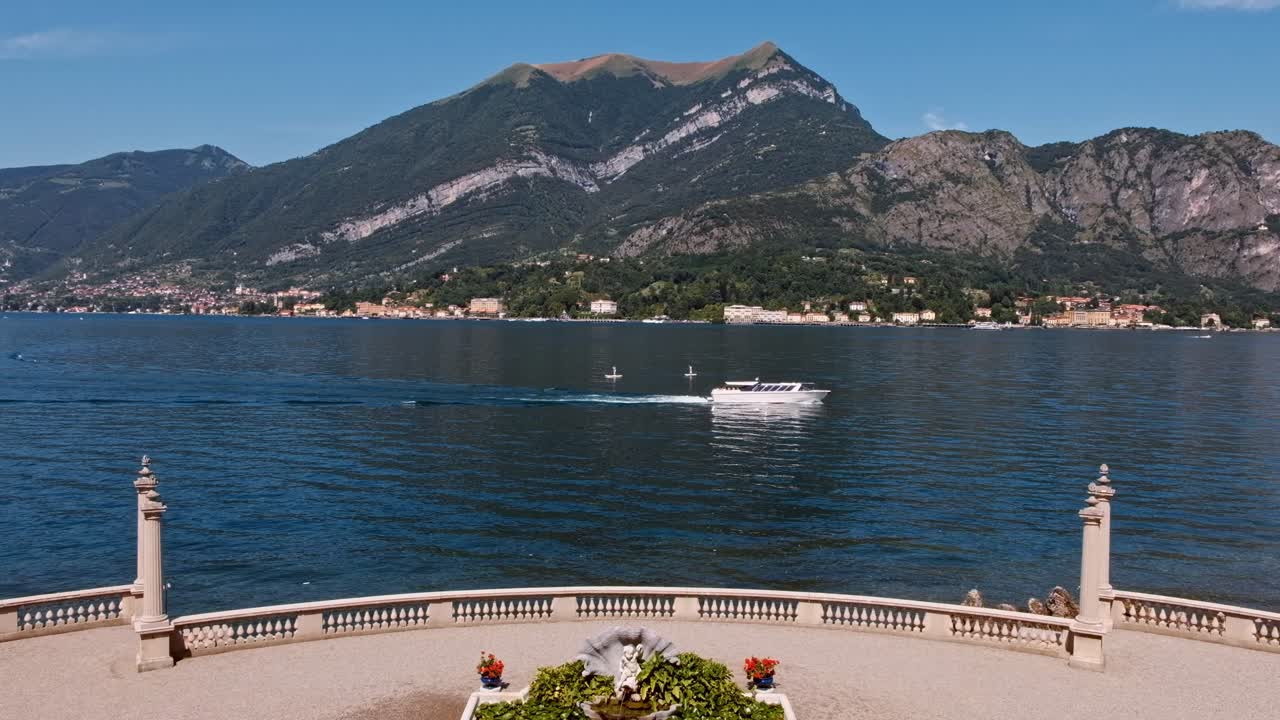 Scenic shot of a boat floating on Como lake near the coastline in Lombardy, Italy