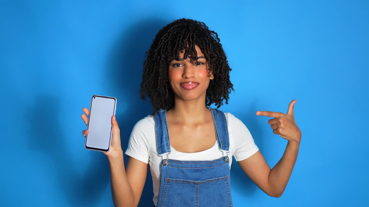 Woman holding a phone on a blue background