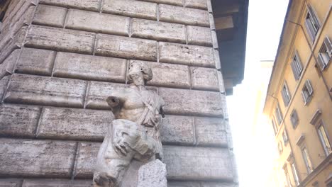 pasquino, a battered hellenistic-style statue in the city center of rome famous for being a talking statue
