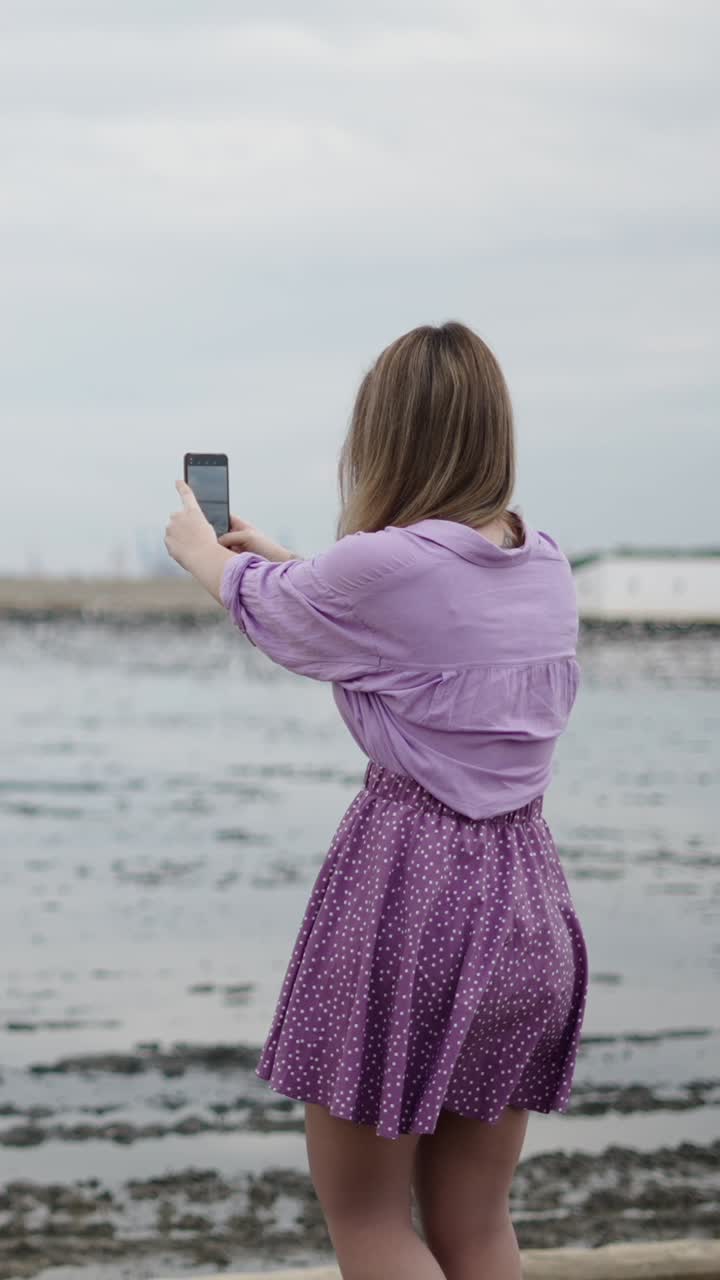 Woman taking a selfie at the beach