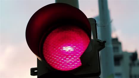 red traffic light at sunset. close up. 4k resolution.