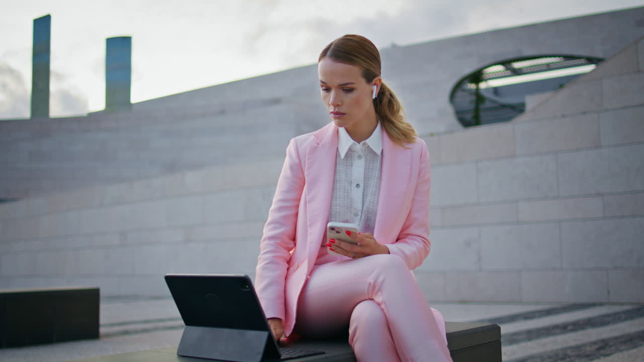 Business woman studying online sitting bench with tablet. Girl listening course