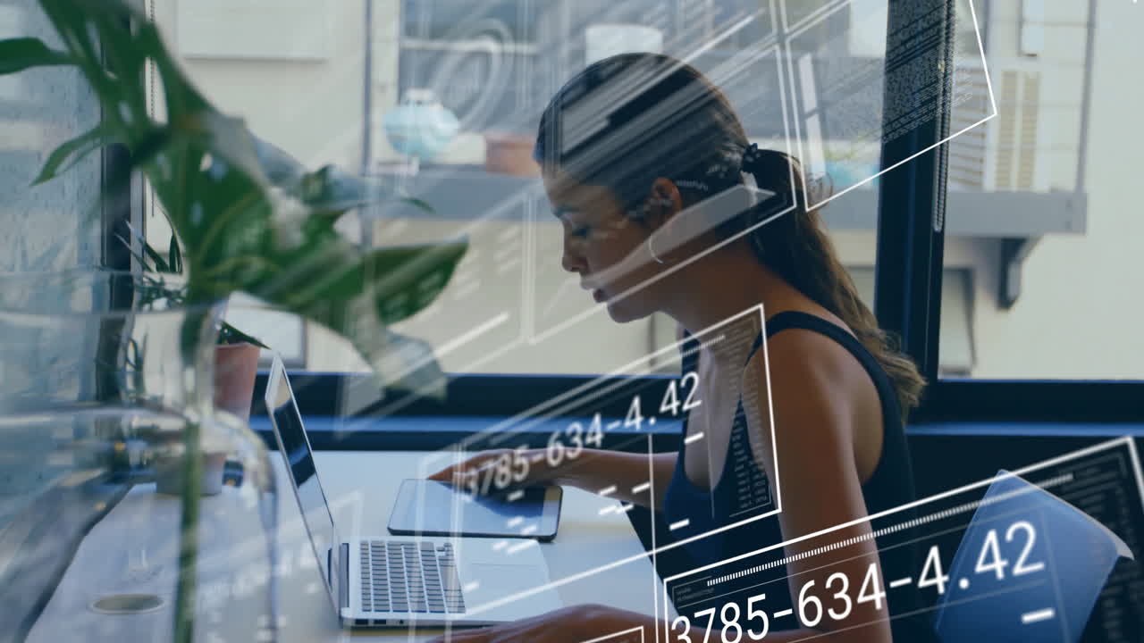 Working on laptop, woman in school with animation overlaying her workspace