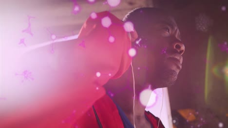 estructuras moleculares brillantes flotando contra el boxeador afroamericano que lleva auriculares