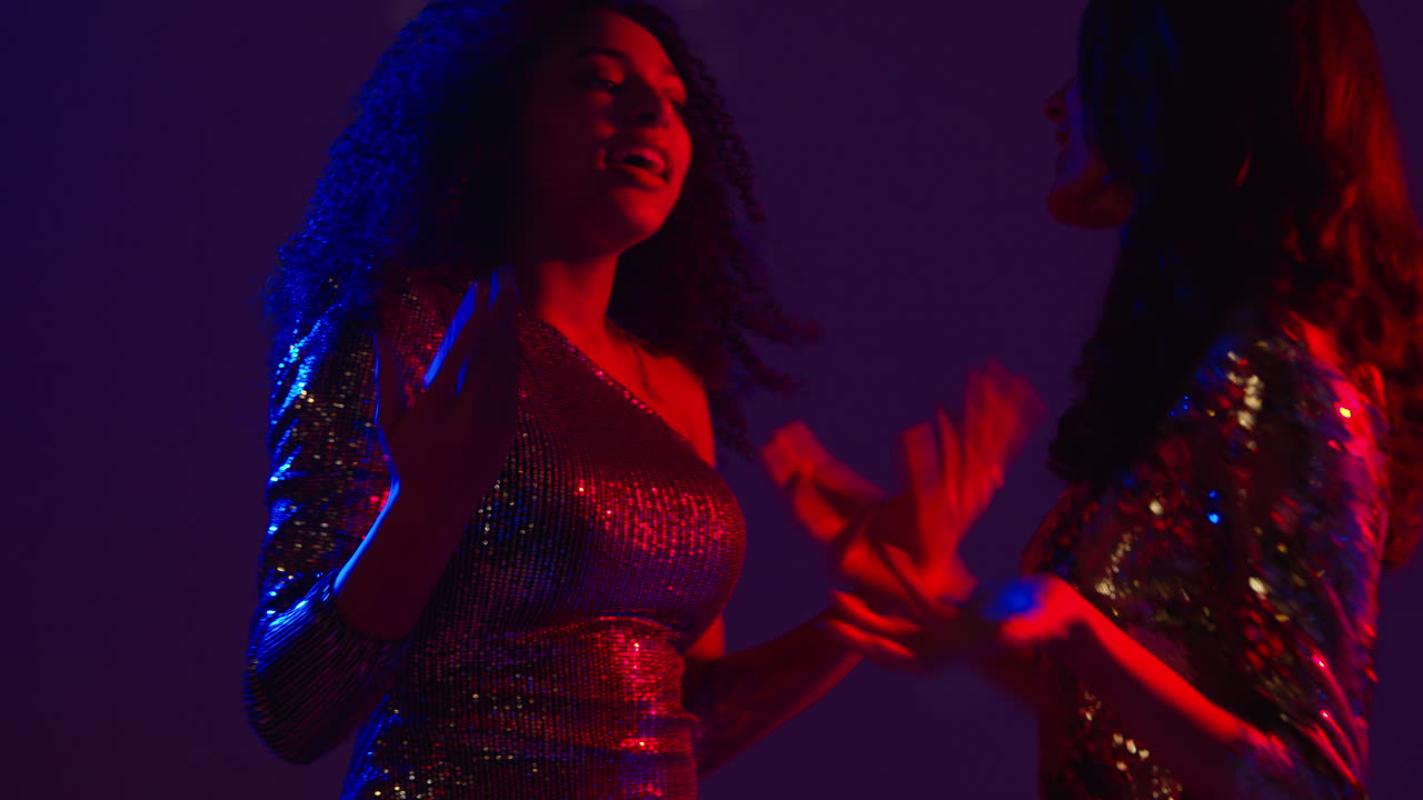 Close Up Of Two Women In Nightclub Bar Or Disco Dancing Together Shot In Real Time