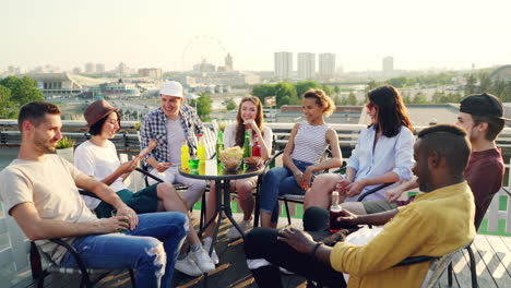 friends having a rooftop party with a city view