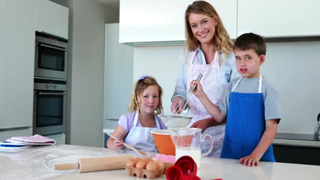 happy mother and children making a cake together