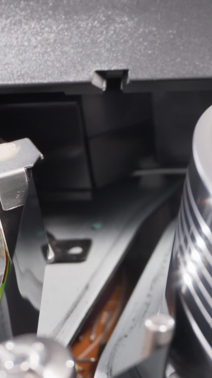 Tape reading head with microchip operates with videocassette in recorder extreme closeup. Old tool for playing video. Vintage domestic technology