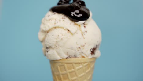 pouring sauce chocolate ice cream chocolate chip in waffle cone.