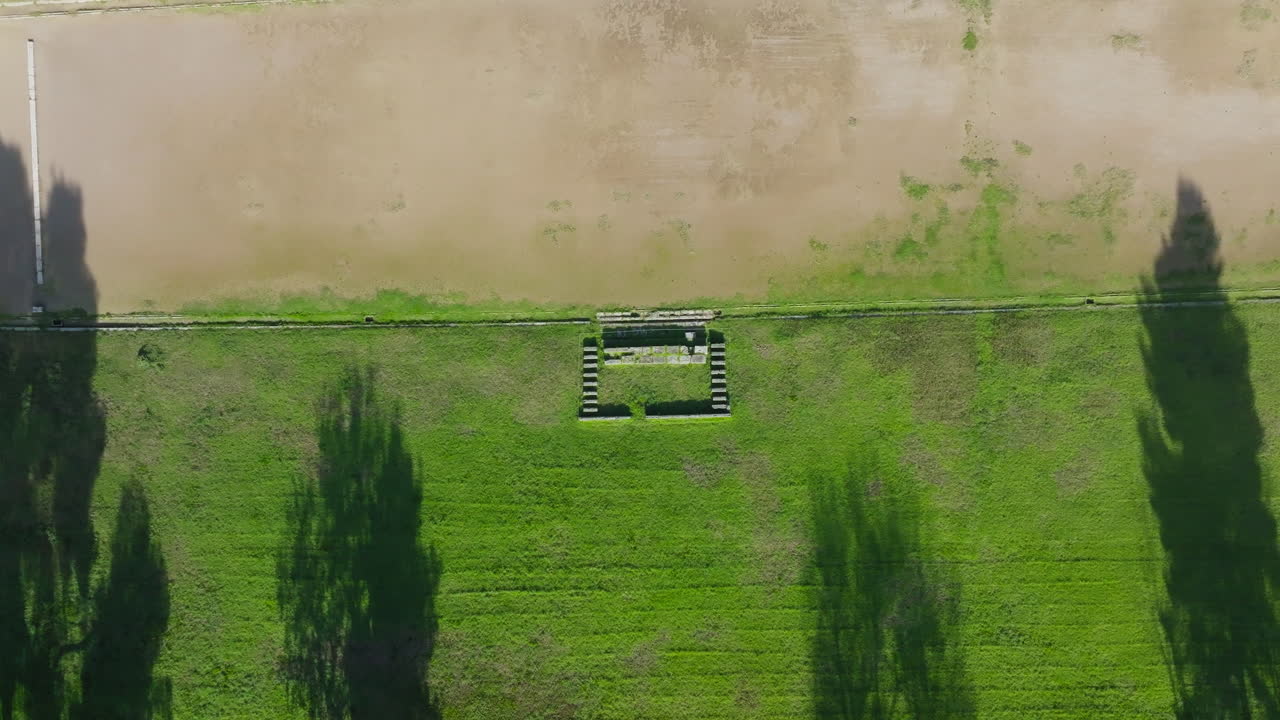 Aerial top shot overview of Olympia stone relics, surrounded by grass and tree-covered grounds