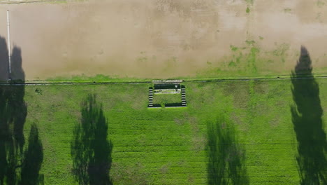 aerial top shot overview of olympia stone relics, surrounded by grass and tree-covered grounds
