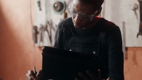 person working on digital tablet in a workshop