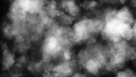 Puffy puffs of smoke on an isolated black background
