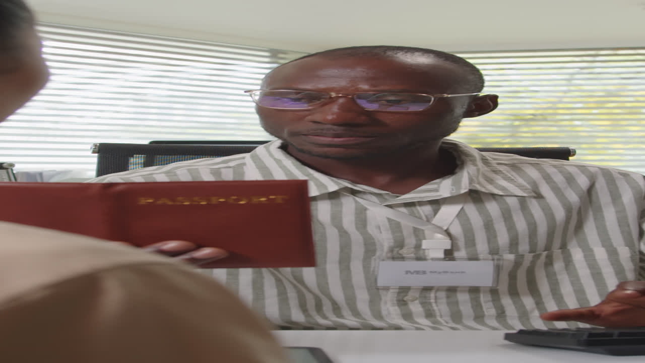 Bank Manager with Passport Filling Documents for Clients Loan