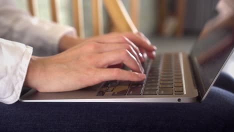 closeup shot of business woman typing on laptop computer working from home, beautiful female professional user lady using technology doing remote online job at home