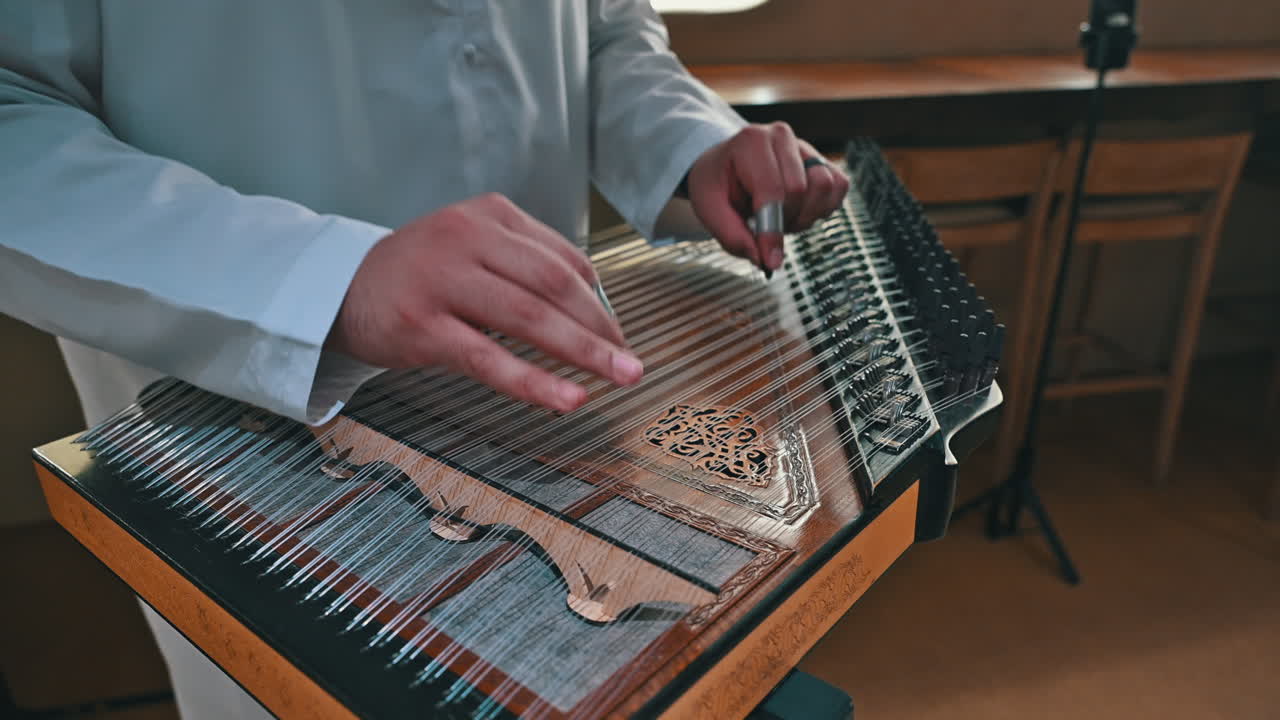 An Arab musician plays the qanun, producing intricate melodies that define the soul of Arabic music