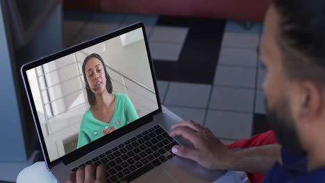 Middle-eastern-man-having-a-video-call-with-female-colleague-on-laptop