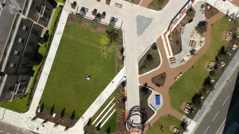 wide, rising aerial video of city quays gardens in belfast, northern ireland, uk on a bright and sunny day. produced in 4k, 60fps and with rec709 color.